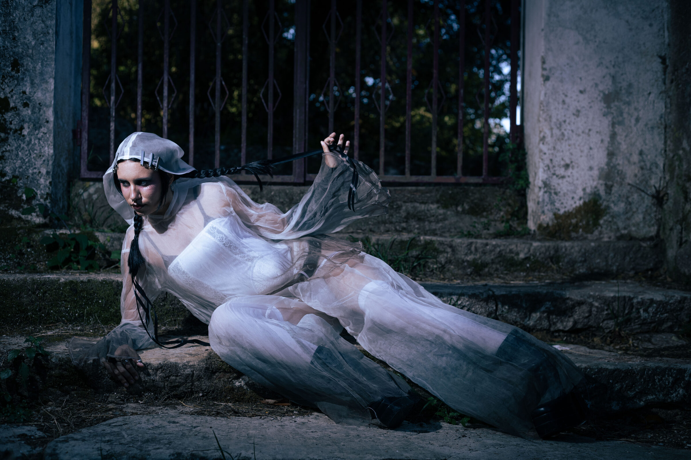 Fashion Editorial - Reclining on stone steps in sheer white